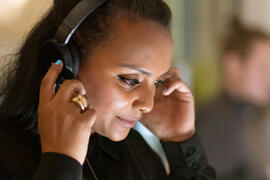 Woman listens to new audiobooks at Frankfurt Audio at Frankfurter Buchmesse 